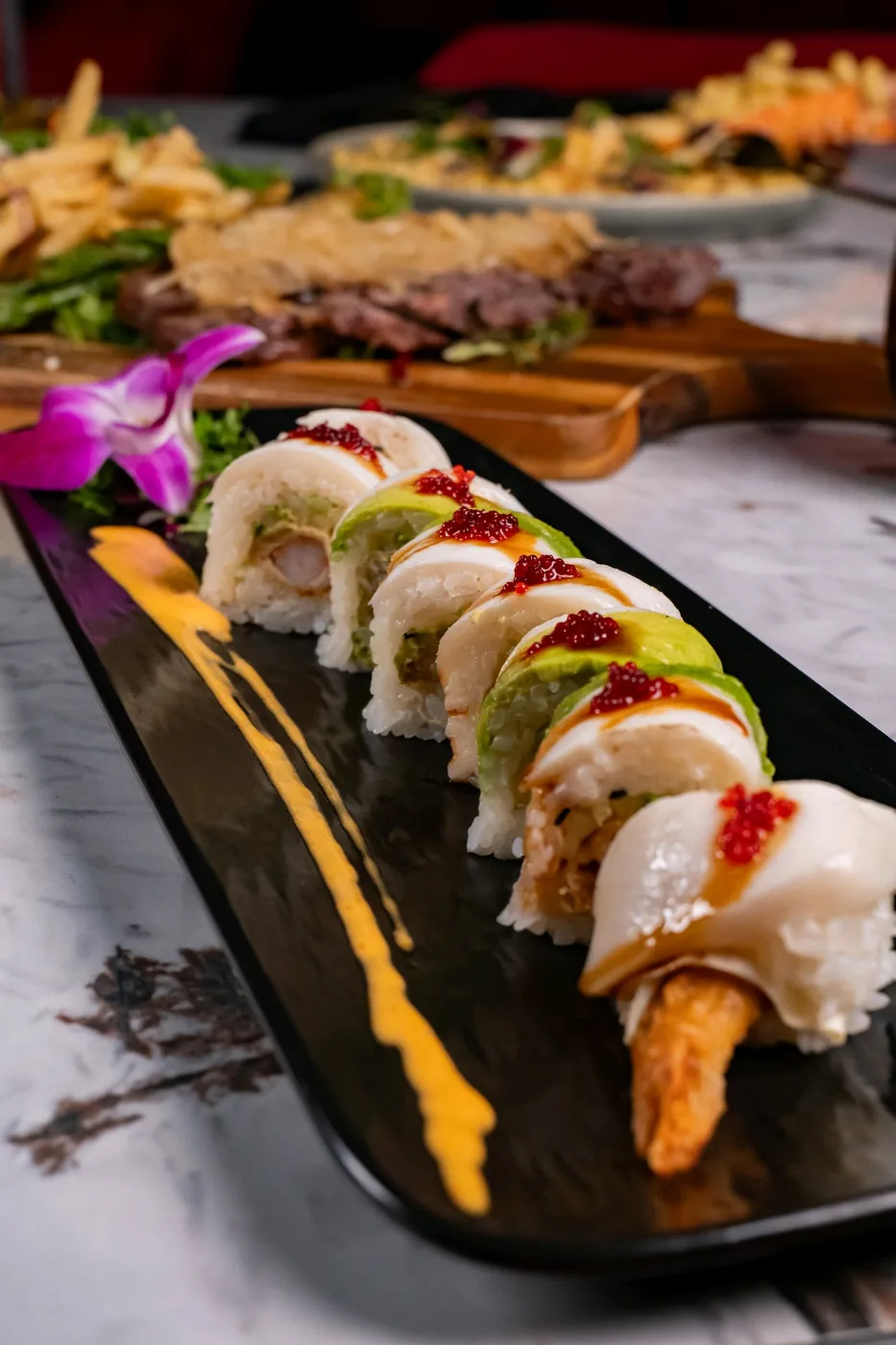 Mousai sushi presented on the original black serving platter